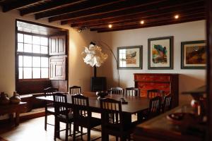 a dining room with a table and chairs and a chandelier at Masoala in Tacoronte