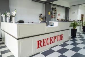 a restaurant with a reception counter with a red sign at HOTEL N Residence in Timişoara