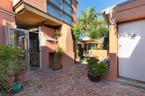 a courtyard with potted plants next to a building at The Bohemian Guesthouse in Cape Town