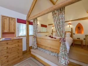 a bedroom with a bed and a dresser at The Linney in Bideford