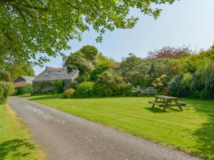 a picnic table in the grass next to a road at The Linney in Bideford