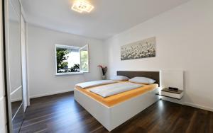 Ένα ή περισσότερα κρεβάτια σε δωμάτιο στο Apartments Mary
