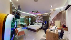 um quarto com uma cama, uma mesa e cadeiras em Motel DUBAI BH em Belo Horizonte