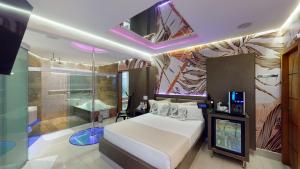 a bedroom with a bed and a shower and a television at Motel DUBAI BH in Belo Horizonte