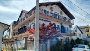 a building with balconies and a pole at Vila Massimo in Eforie Nord