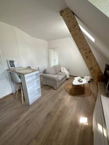 a living room with a couch and a table at Bel appartement cosy proche de la frontière Suisse in Villers-le-Lac