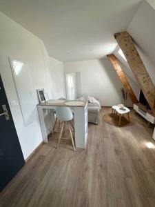 a room with a desk and a bed in a attic at Bel appartement cosy proche de la frontière Suisse in Villers-le-Lac