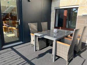 a table and chairs sitting on a patio at Glückszeit-Itter in Dorfitter