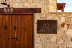 una señal en el lateral de un edificio de piedra con una puerta en Harma Traditional Boutique Suites en Pafos