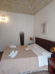 a bedroom with a large bed with towels on it at casa vacanze pupo 2.0 in Favignana