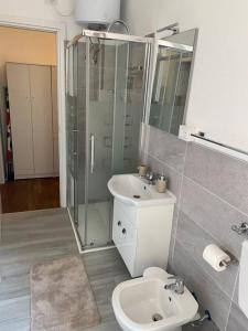 a bathroom with a toilet and a shower and a sink at Casa Eugenia in Varese