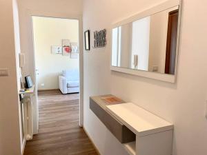 a white room with a counter and a mirror at Casa Eugenia in Varese
