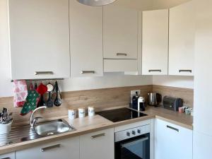 a kitchen with white cabinets and a sink at Casa Eugenia in Varese