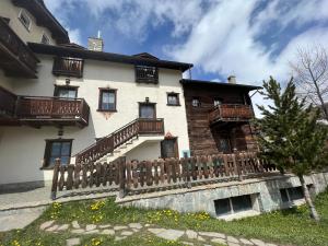 a house with a wooden fence in front of it at Appartamenti Stefano in Livigno