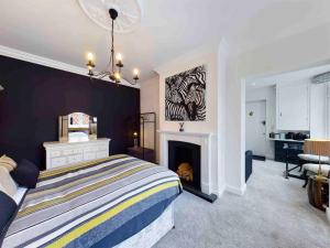 a bedroom with a bed and a fireplace at The Stables Annex in Hinckley