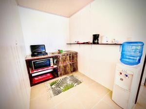 a kitchen with a small refrigerator and a microwave at Tikehau cosy lodge in Tikehau