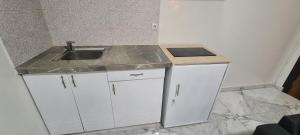 a kitchen with a sink and a counter top at Appartement meublé grand luxe à Essos in Yaoundé