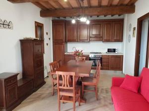 a kitchen with a table and chairs and a couch at Il Panorama in Montescudaio