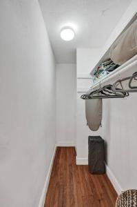 a hallway with a room with white walls and wooden floors at By Las Olas Bl, Pool, Parking, Remodeled & Central in Fort Lauderdale +37 photos