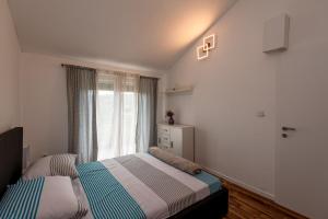 a bedroom with two beds in front of a window at Holiday House Mablo with pool & jacuzzi in Šibenik +51 photos