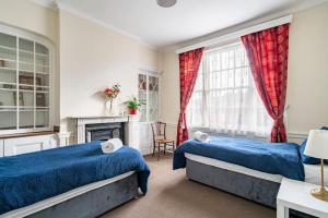 a bedroom with two beds and a fireplace at Perfect for Large Family & Friends, Free Parking, Games in Reading