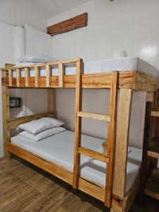 a couple of bunk beds in a room at Big BamBoo Beach Resort Sipalay in Sipalay