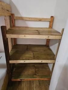 a wooden shelf in the corner of a room at Big BamBoo Beach Resort Sipalay in Sipalay