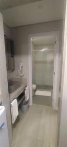 a bathroom with a sink and a tub and a toilet at Livyd Angra dos Reis in Angra dos Reis