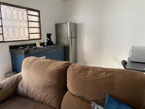 a couch sitting in a kitchen with a refrigerator at Flats LaMaison, Arse 81 in Palmas