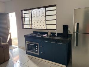 a kitchen with a stove and a sink and a refrigerator at Flats LaMaison, Arse 81 in Palmas