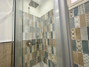 a bathroom with a shower with a glass door at Appartamento 31 H in Taormina +34 photos