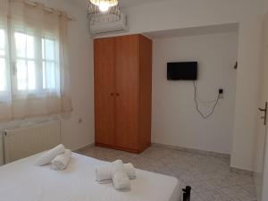 a bedroom with a bed and a tv on the wall at Veatriki Lefkada in Lefkada