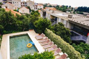 a swimming pool with lounge chairs and a pool float at Deluxe apartment Marghareta in Dubrovnik
