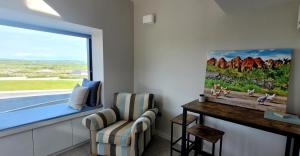 a living room with a window and a chair at Moher Lodge in Liscannor