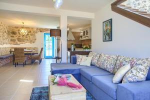 a living room with a blue couch and a table at Luxury Villa Ive With Heated Pool, Finnish Sauna, Infrared Sauna, Pet Friendly in Krk