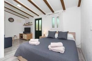 a bedroom with a large bed with two towels on it at Sweet Studio with terrace in Dubrovnik