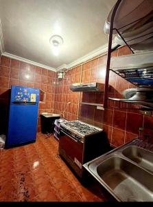 a kitchen with a blue refrigerator and a sink at Giza Great Pyramid in Cairo