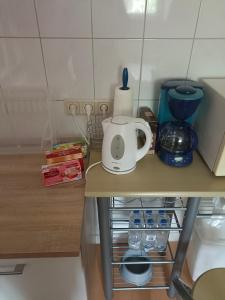 a kitchen counter with a tea kettle on it at Nette Kuschelige Wohnung in Bochum
