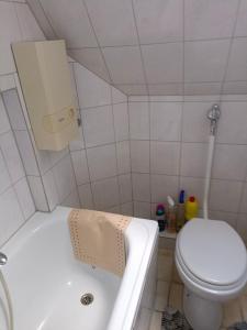 a bathroom with a toilet and a bath tub at Nette Kuschelige Wohnung in Bochum