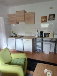 a small kitchen with a couch and a microwave at Nette Kuschelige Wohnung in Bochum
