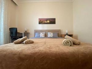 a bedroom with a large bed with two pillows on it at family house in Xanthi