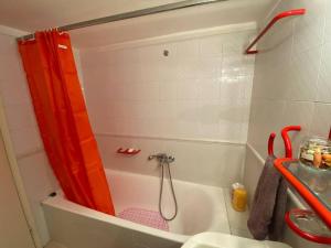 a bathroom with a shower with a red shower curtain at family house in Xanthi