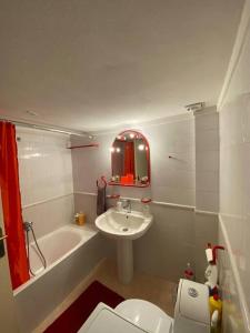 a bathroom with a sink and a toilet and a tub at family house in Xanthi
