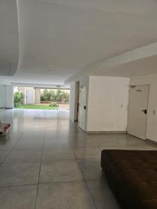 a large empty room with a couch in the middle at LaMari in Buenos Aires +5 photos