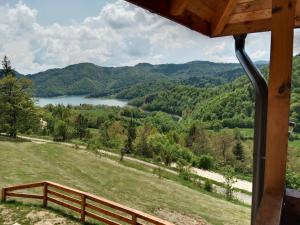 a view of a lake from a cabin at Zaovinska Panorama I in Bajina Bašta
