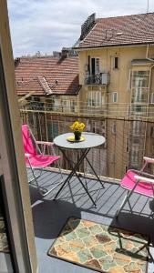 a patio with a table and chairs on a balcony at Ampio e luminoso bilocale in Turin