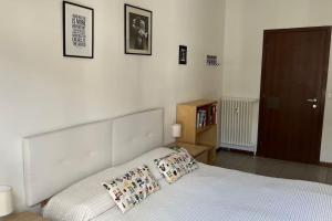 a bedroom with a bed with two pillows on it at Ampio e luminoso bilocale in Turin