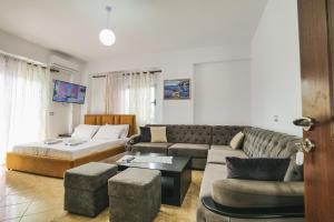 a living room with a couch and a bed at HOTEL RENATO in Ksamil