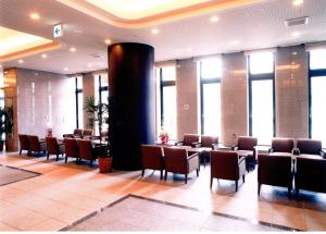 a lobby with chairs and tables in a building at Route Inn Grantia Hakodate Ekimae in Hakodate