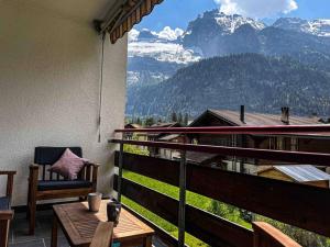 a balcony with a chair and a view of a mountain at Swiss Alps Lodge in Kandersteg